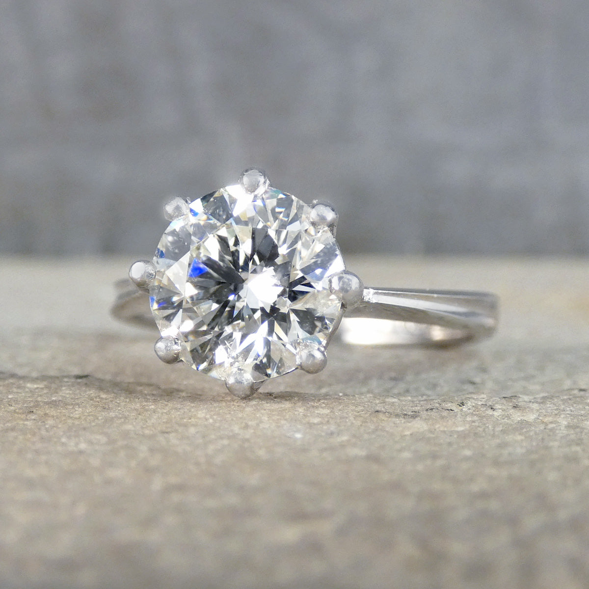 Diamond ring on a textured surface with a blurred background