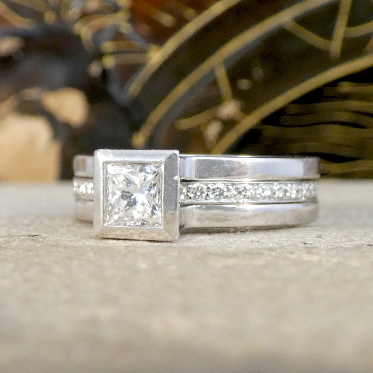 Platinum ring with a diamond on a neutral background