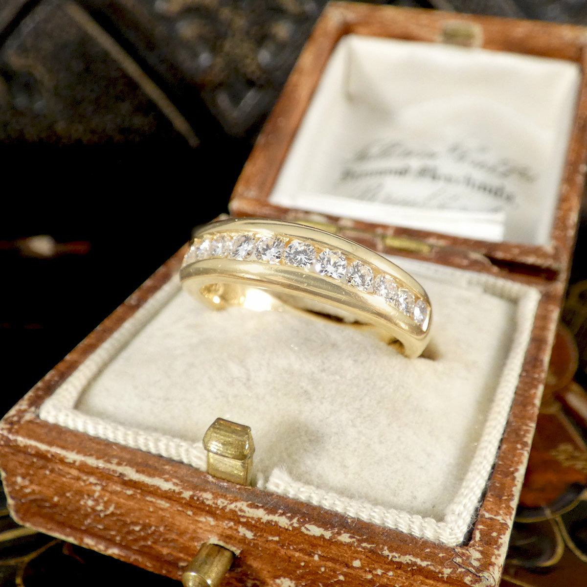Gold ring with diamonds in a wooden box