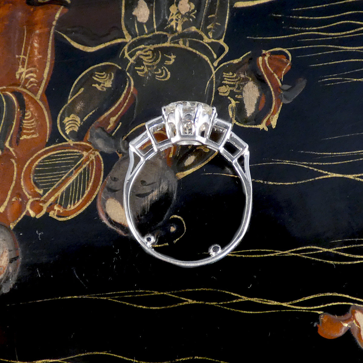 Silver ring with a diamond on a decorative black background