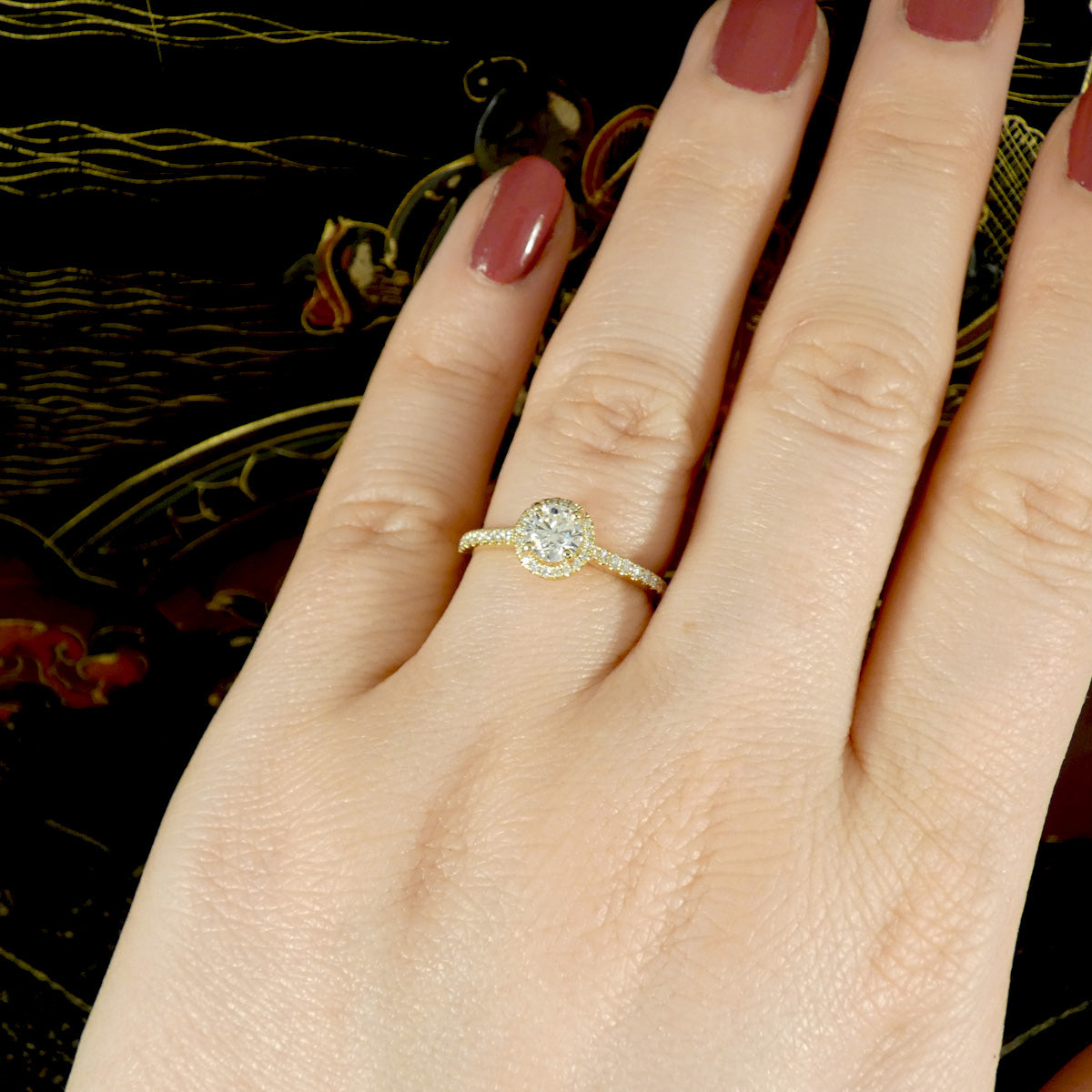 The perfect engagement ring shown on the ring finger on the hand to show size and ratio on a size M finger.