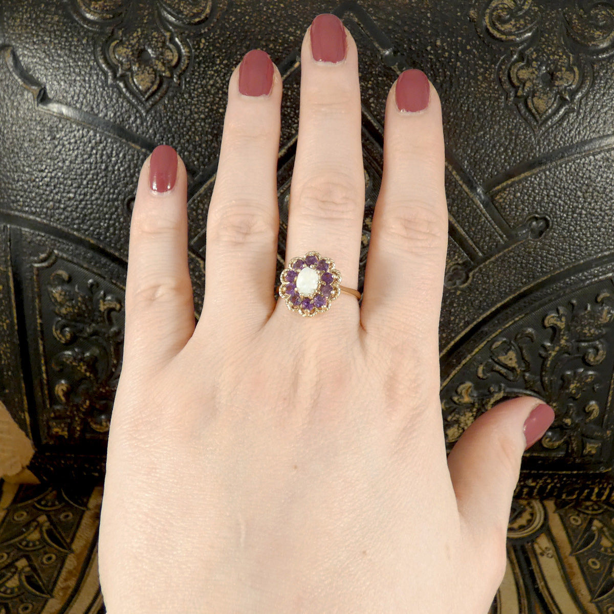 Vintage Opal and Amethyst Cluster Ring in 9ct Yellow Gold with Gold Rope Edge Detail. Amethyst showing bright purple colour with the opal showing a white milky  hue. Shown on hand for size and colour reference.