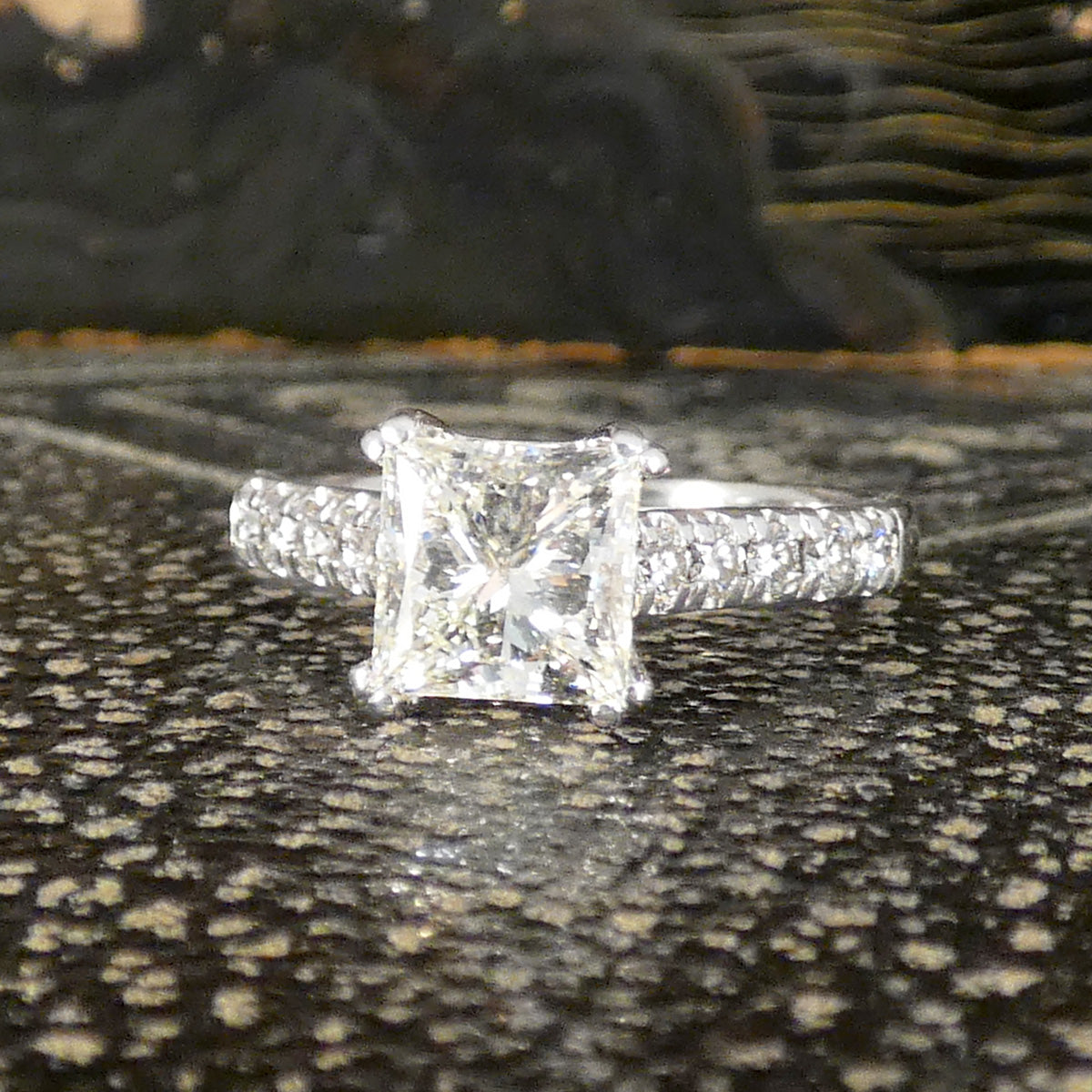 A gorgeous Princess cut Diamond Solitaire ring with diamond set shoulders in 18ct White Gold, the perfect engagement ring. The perfect gift.