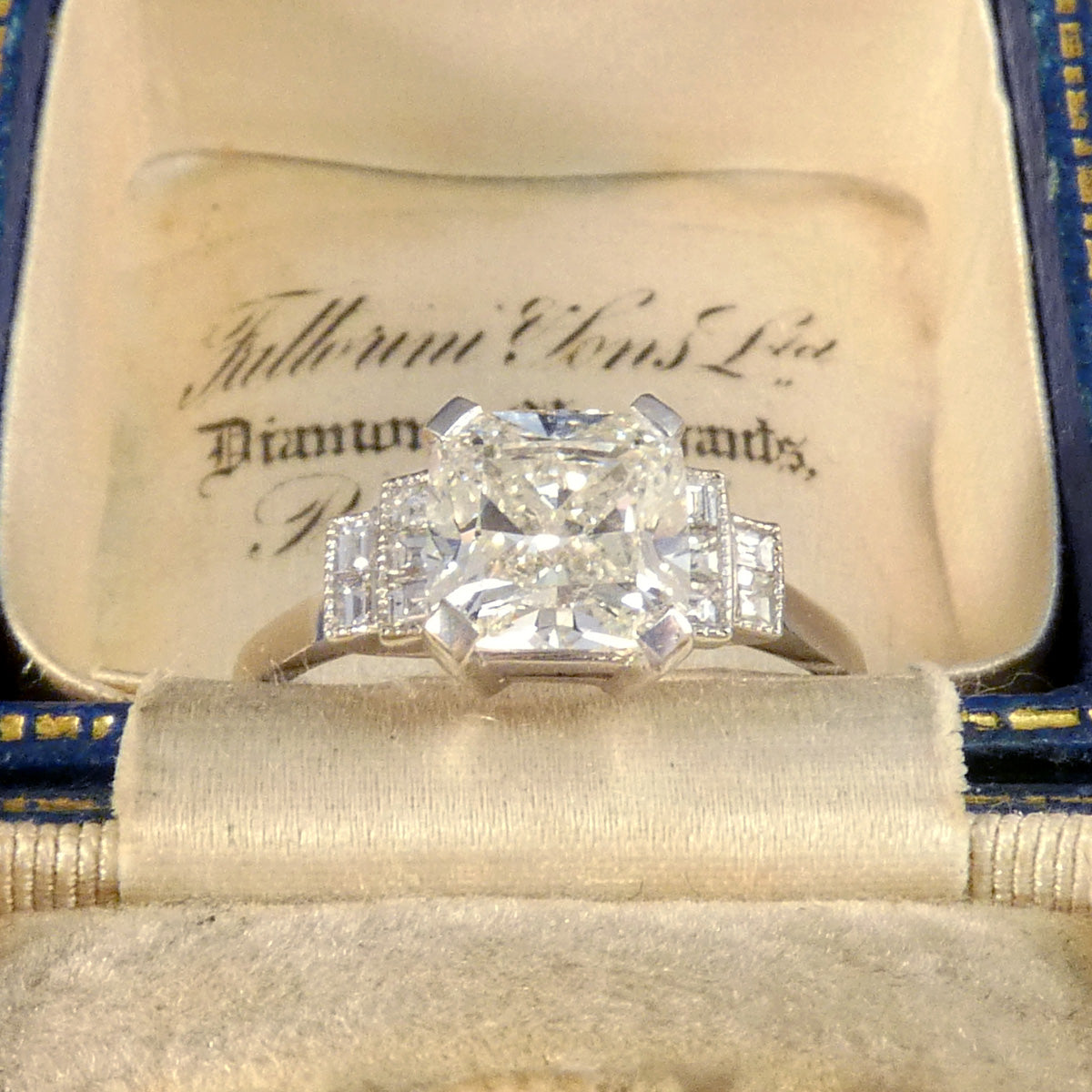 GIA Cert 2.01ct Cushioned Brilliant Cut Diamond Solitaire with Diamond Set Shoulders in Platinum displayed in vintage box.