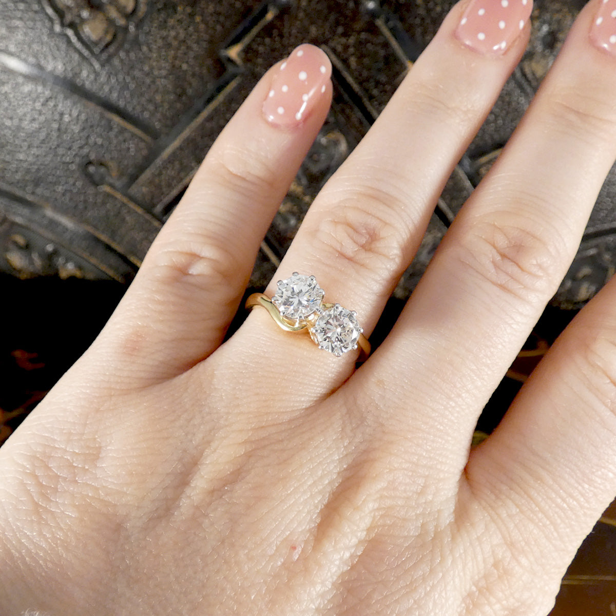 a diamond two stone ring shown on the ring finger