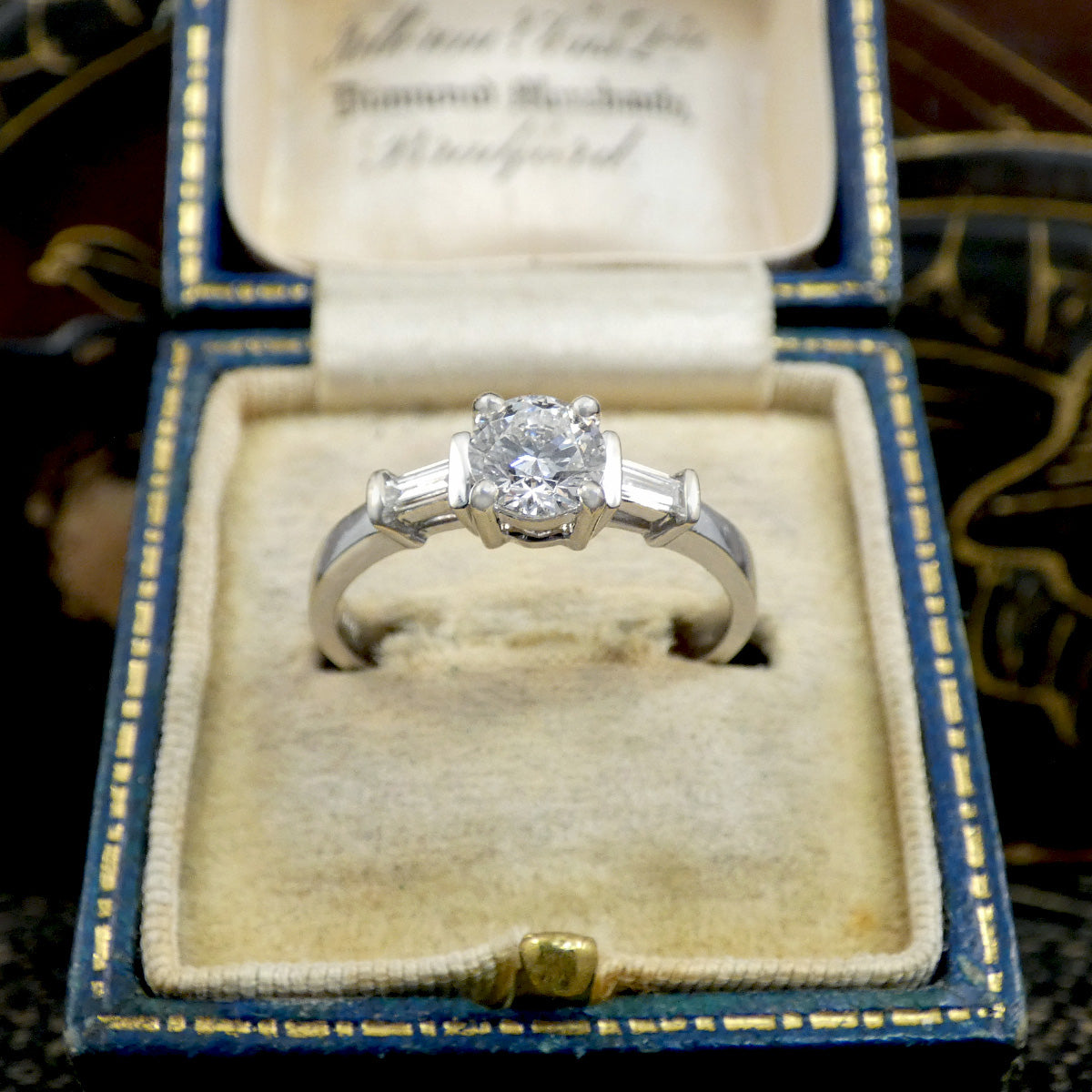 Diamond ring in a blue velvet box with gold edges