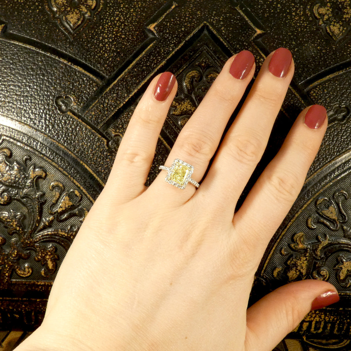 Natural Yellow Radiant Cut Diamond with GIA grading in a four claw setting. Surrounded by a halo of bright white Diamonds and Diamond set shoulders in 18ct White Gold. Perfect engagement ring. Shown on hold for size reference and shown when worn.