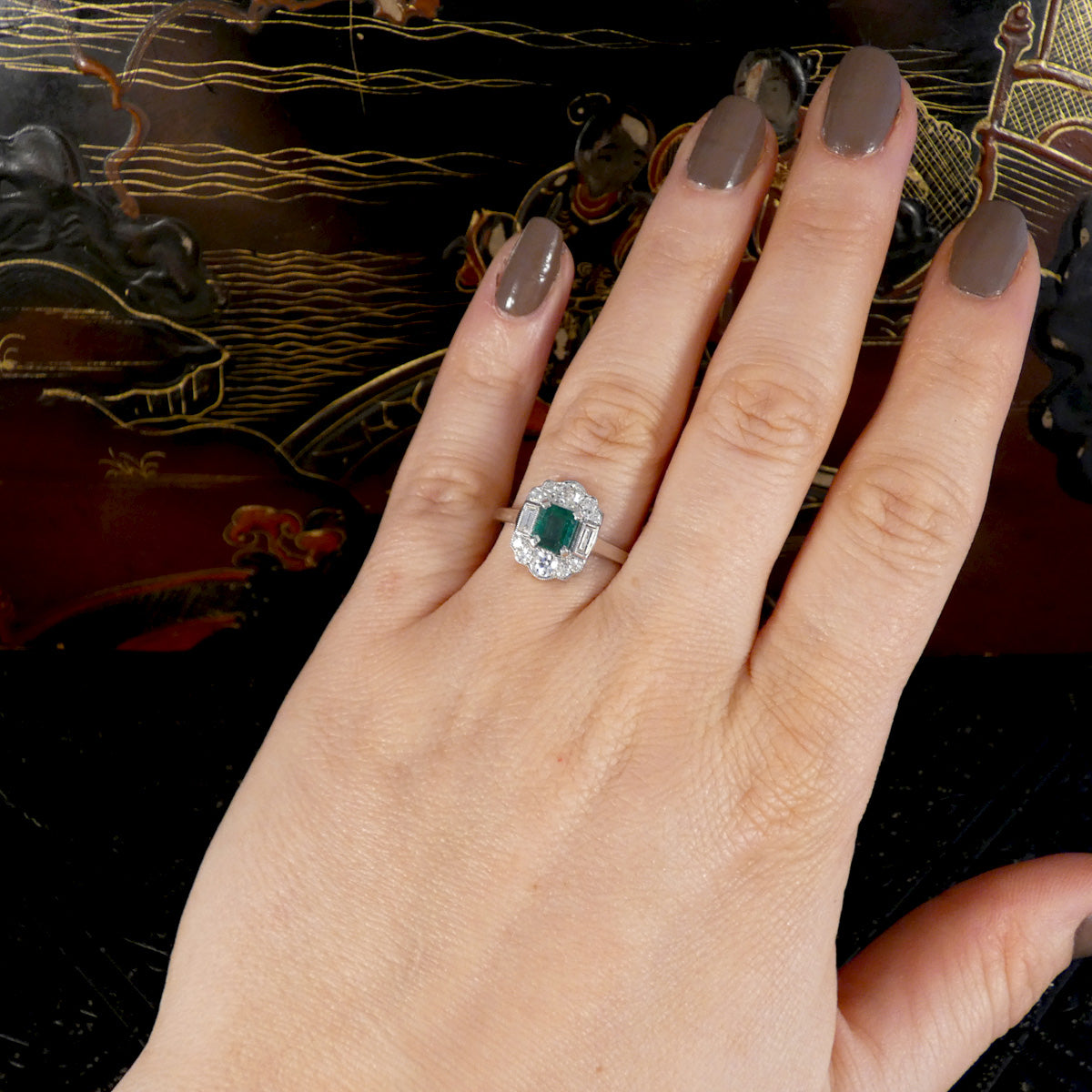 Art Deco Style Emerald and Diamond Cluster ring shown on the hand