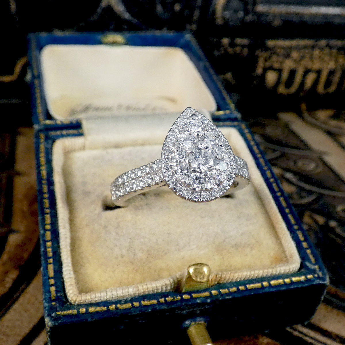 Diamond ring in an open jewelry box with a vintage background