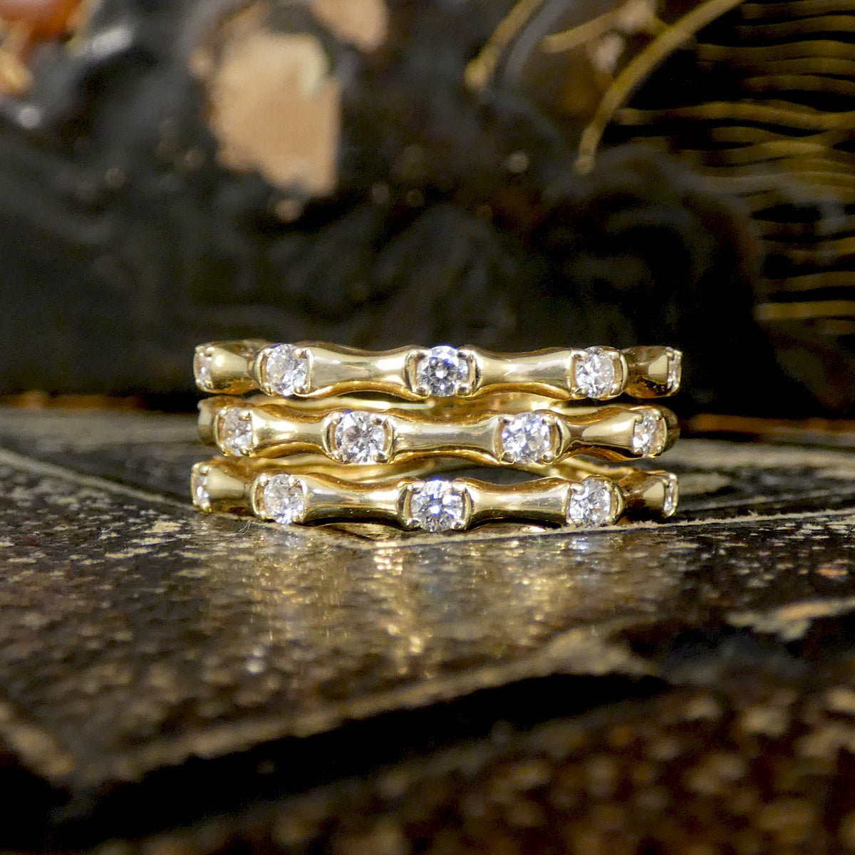 Three strand bamboo style ring in yellow gold with diamonds