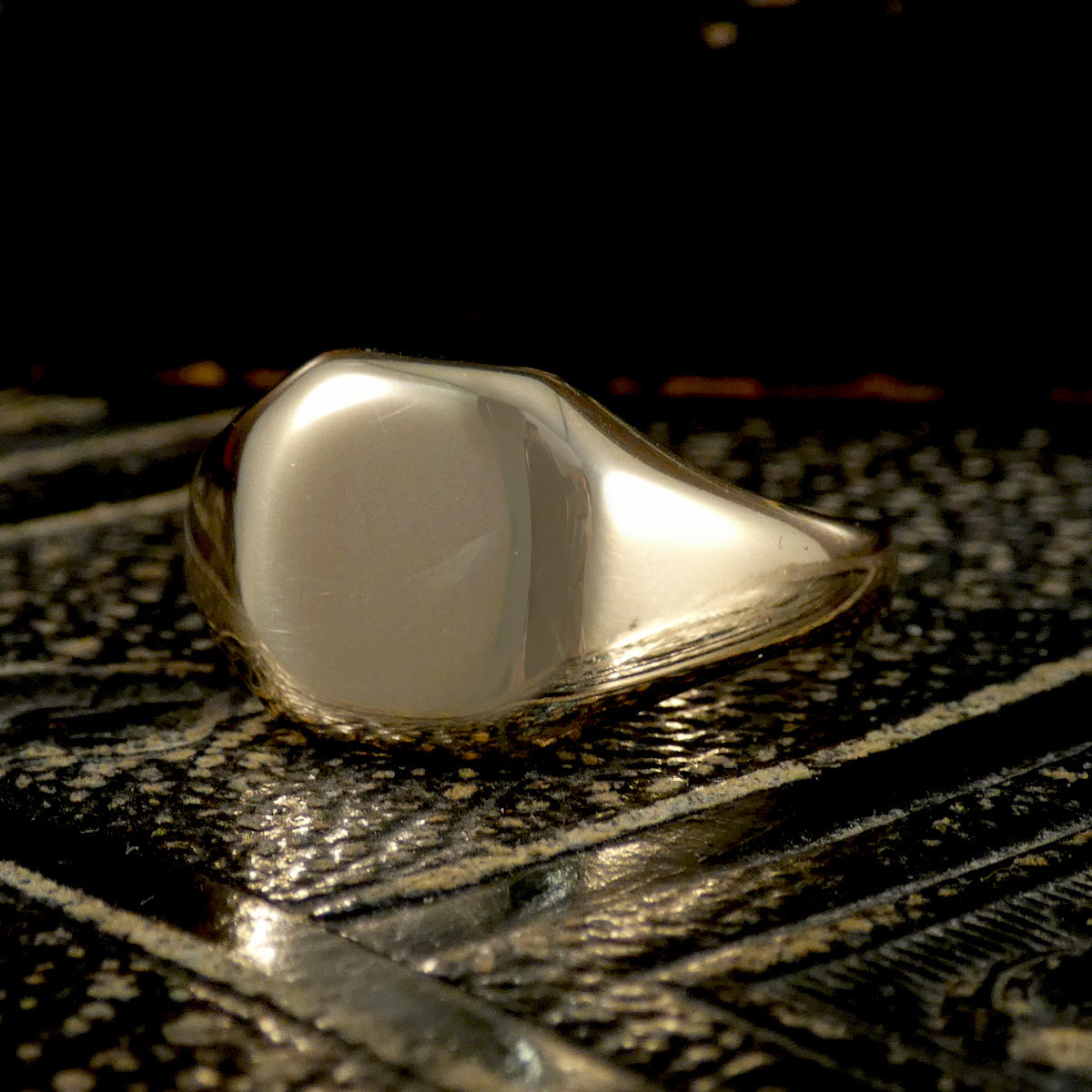 Gold ring on a textured dark surface