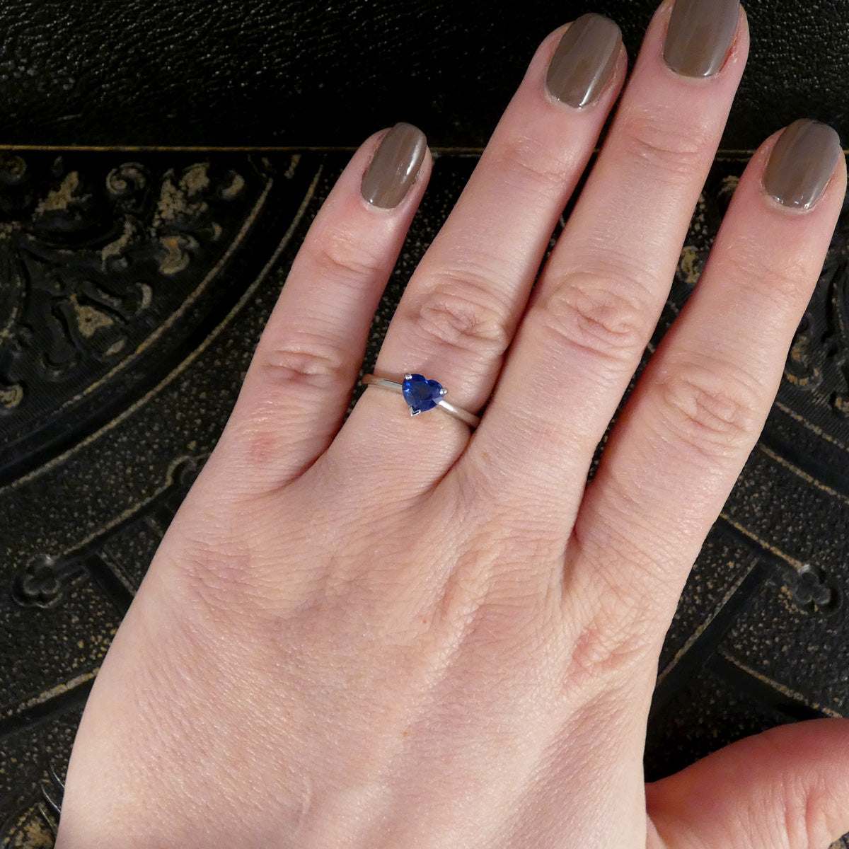 Heart Cut Sapphire solitaire ring in Platinum displayed on the hand