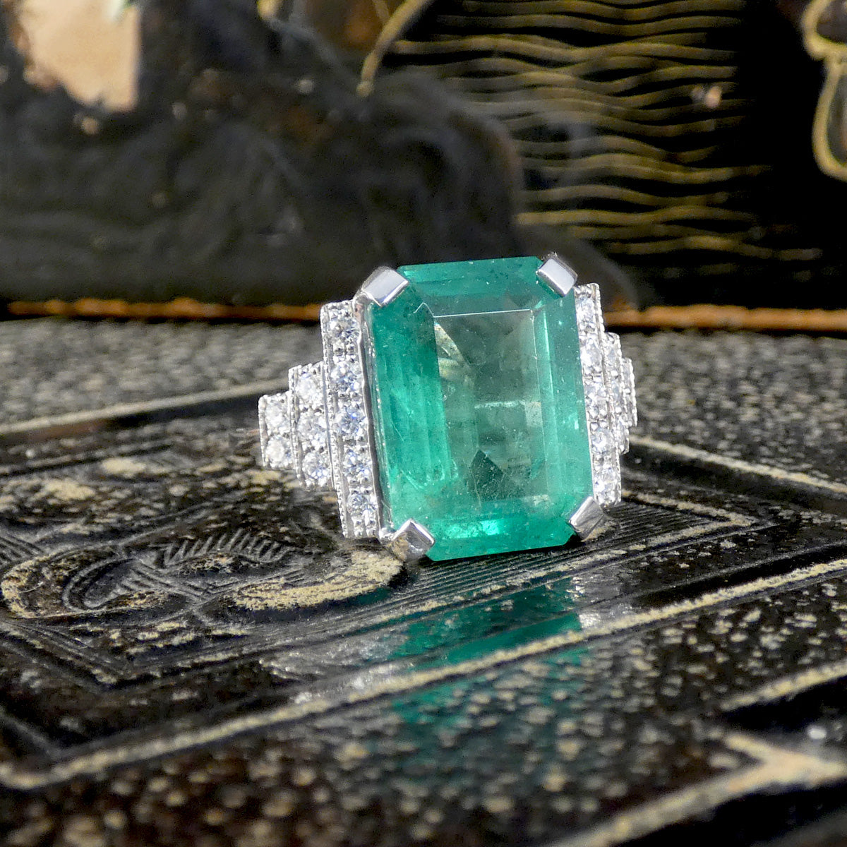 Big and beautiful emerald cut emerald ring showing bright green hue.