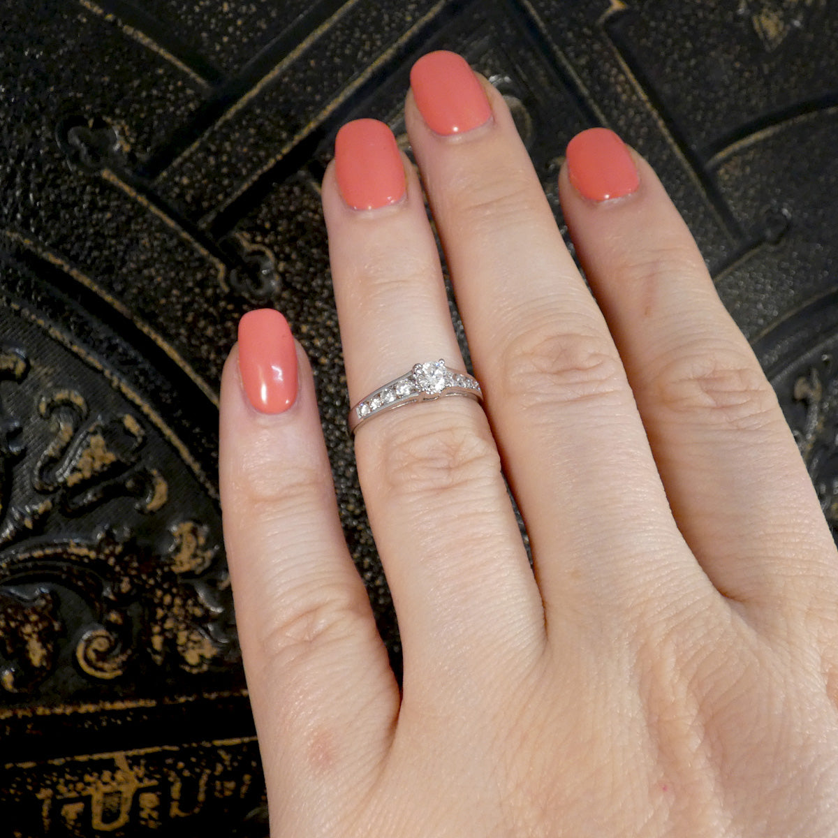 A diamond ring displayed on a hand