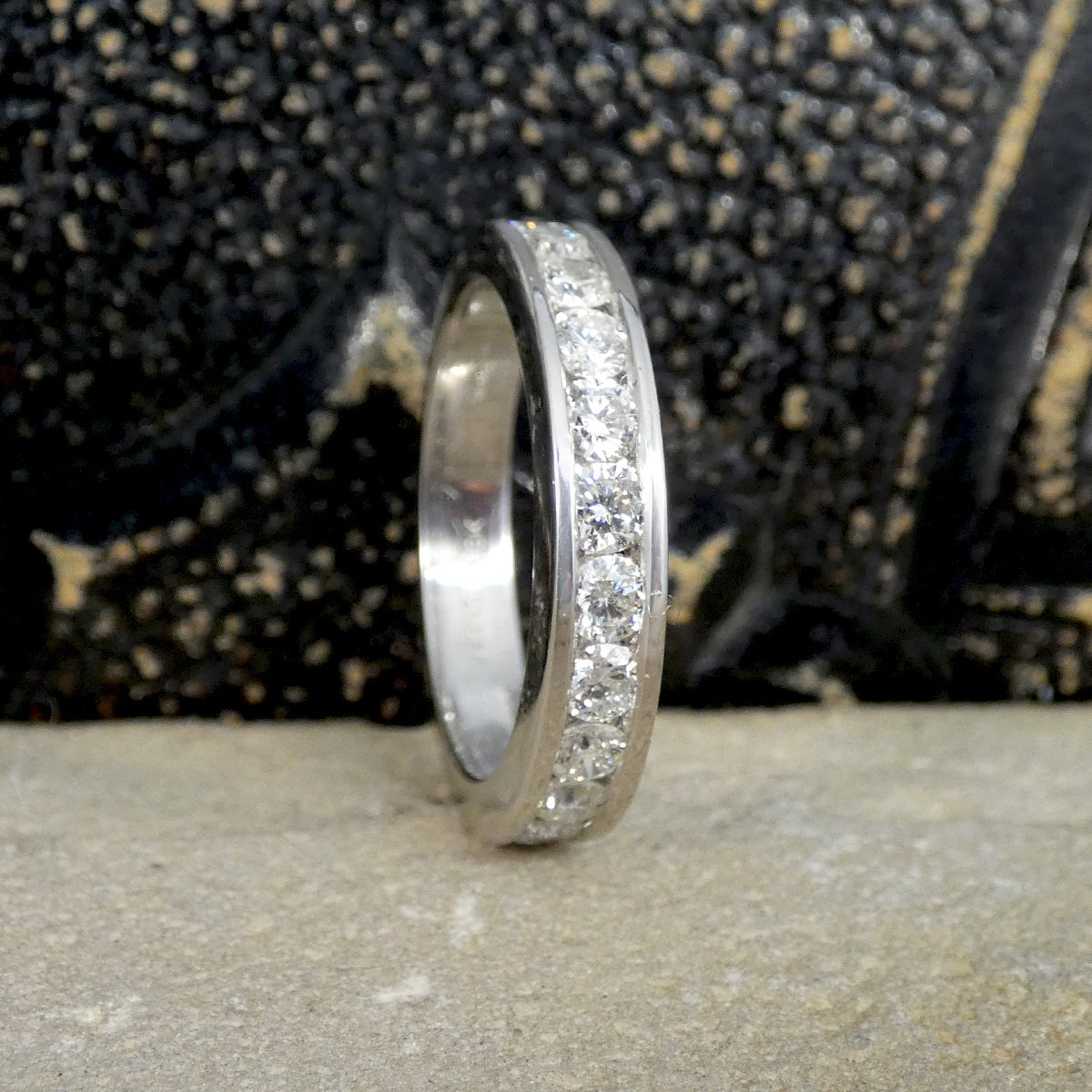 White Gold ring with embedded diamonds on a textured surface
