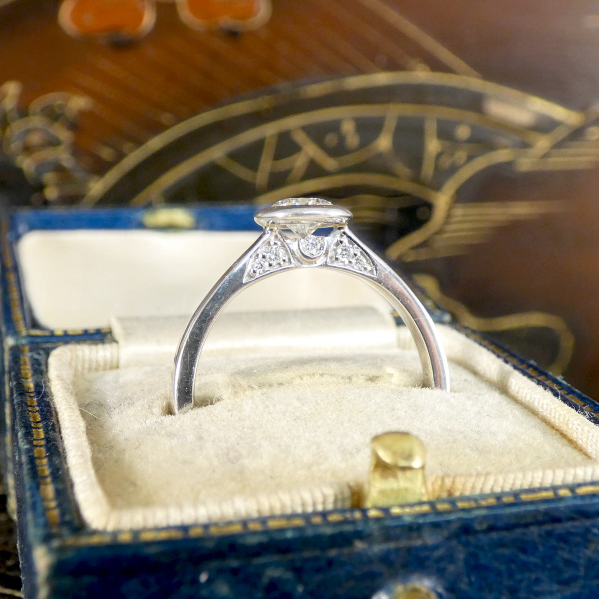Side profile of diamond set gallery detail, adding an extra special touch to a perfect diamond solitaire engagement ring.