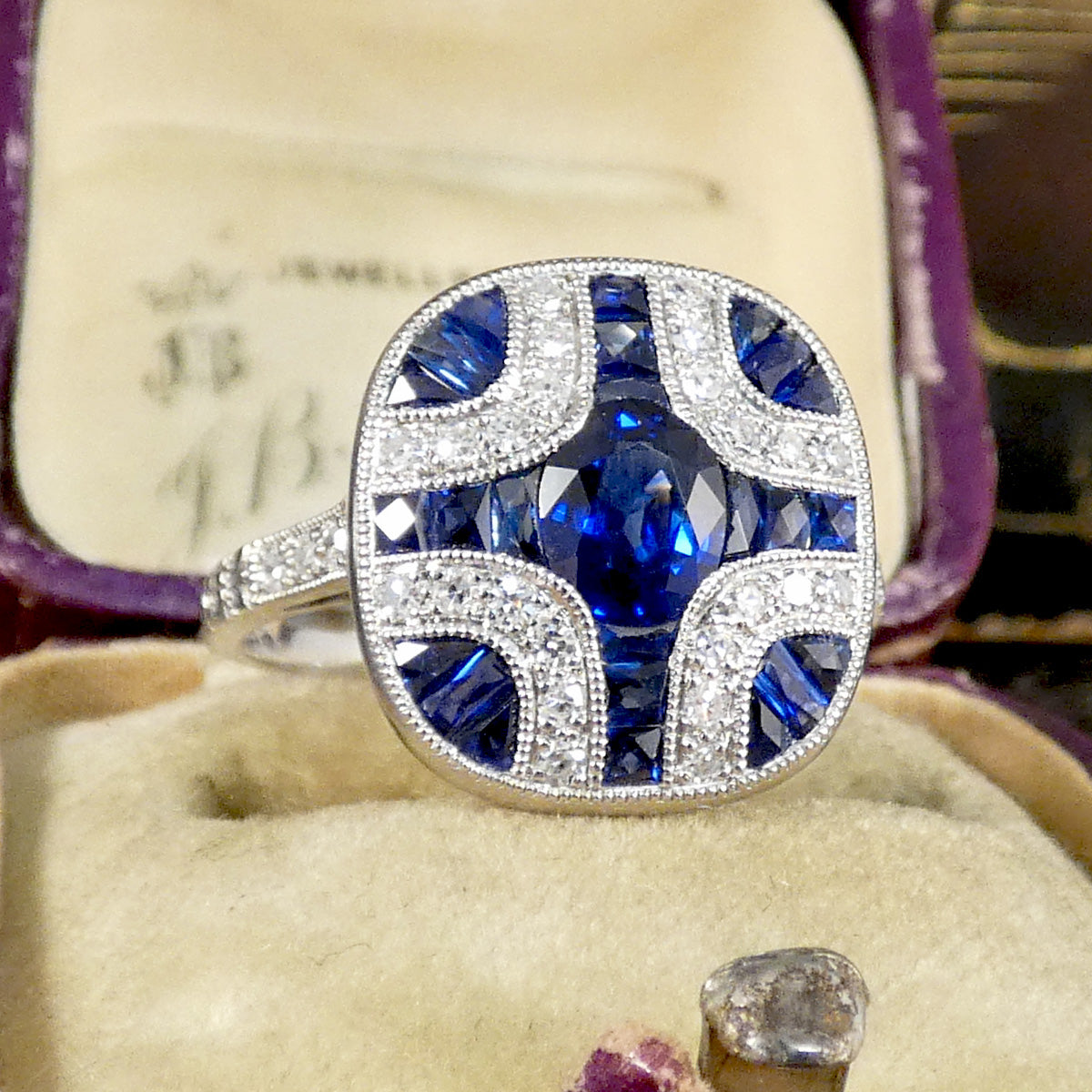 A gorgeous Art Deco style Sapphire and Diamond geometric cross style ring in Platinum.