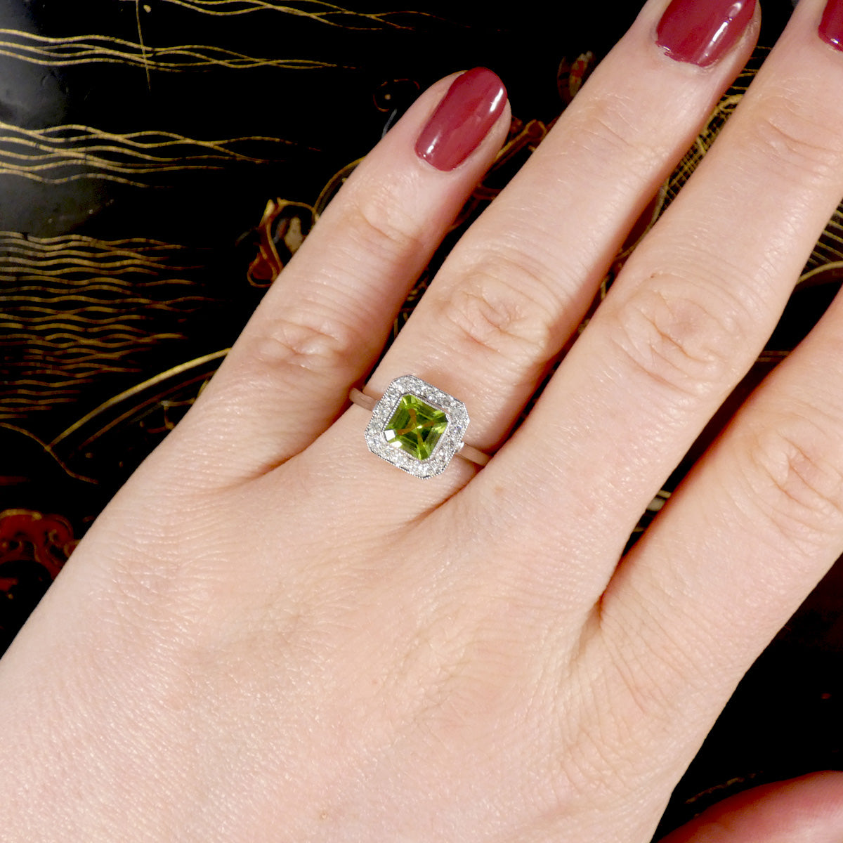 Art Deco Style Peridot and Diamond Cluster Ring in Platinum shown worn on the finger to see perfect size and colour contrast