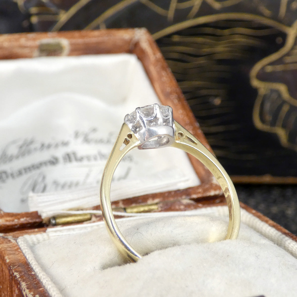 Side profile on solitaire ring showing the classic curtain style setting.