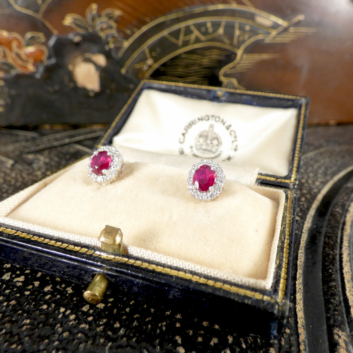 Pair of ruby earrings in a vintage box.