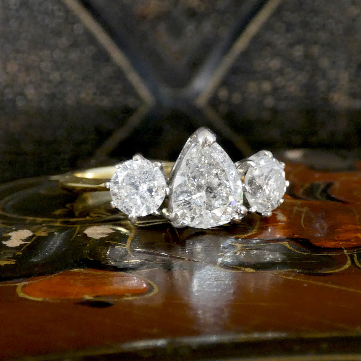 Three diamond salt and pepper diamonds  on a decorative surface with a blurred background