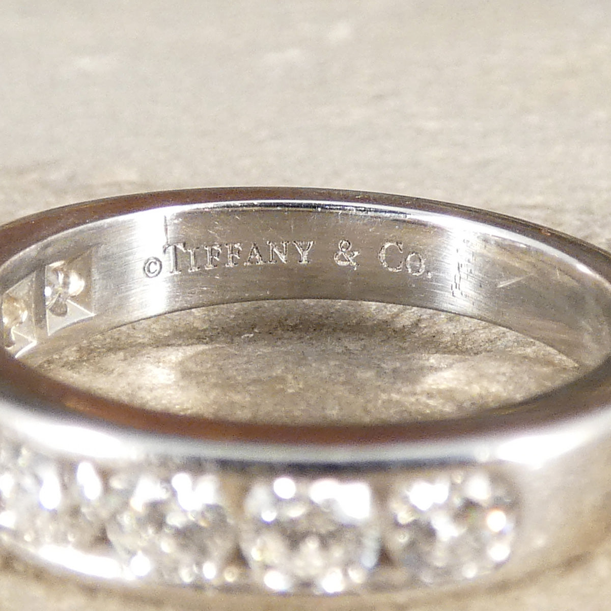 A diamond ring with the Tiffany & Co. hallmark on the inner band