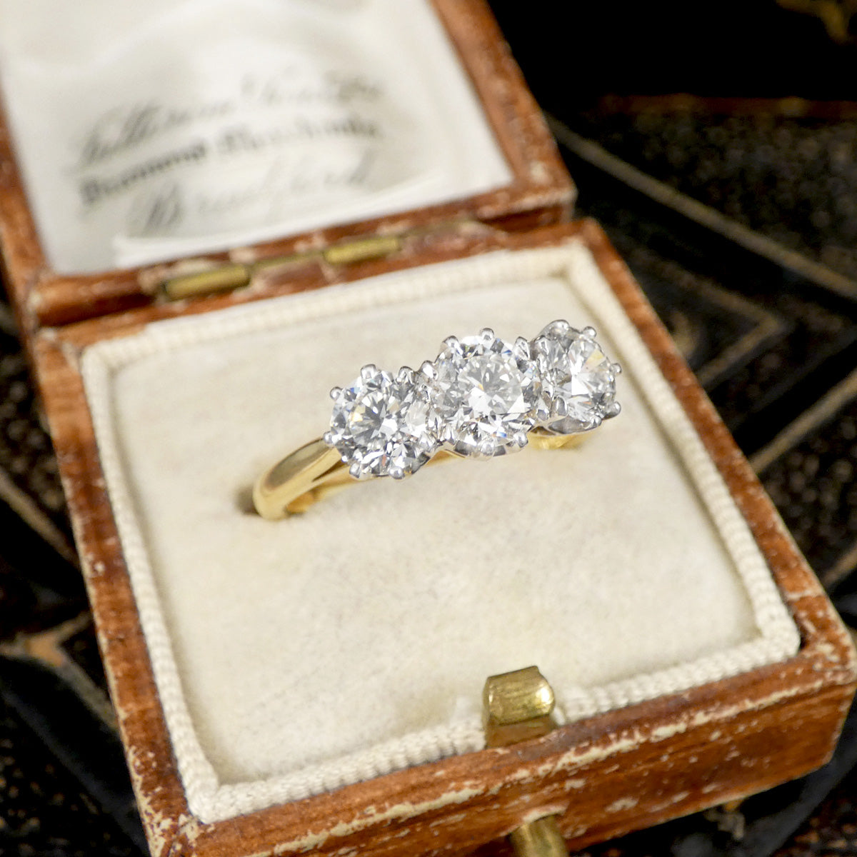 Diamond ring in a wooden box with a blurred background