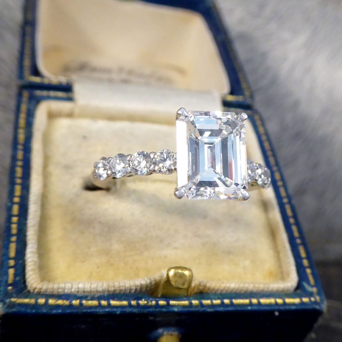 2.60ct Emerald Cut Diamond Solitaire Ring with 0.60ct Diamond Shoulders in Platinum - Wharfedale Antiques
