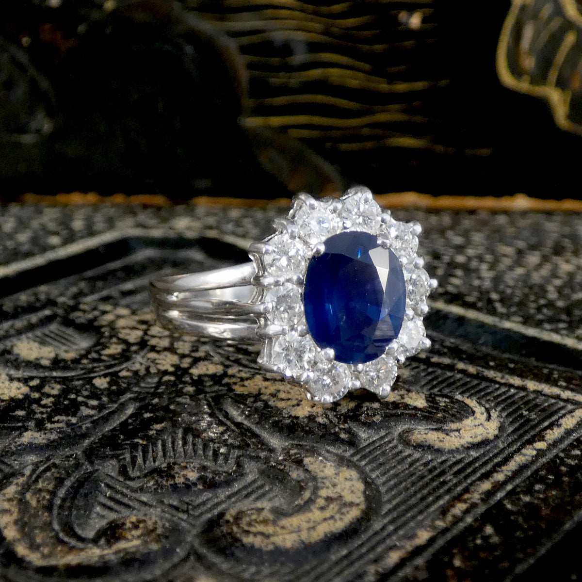 Silver ring with a blue gemstone on a textured surface