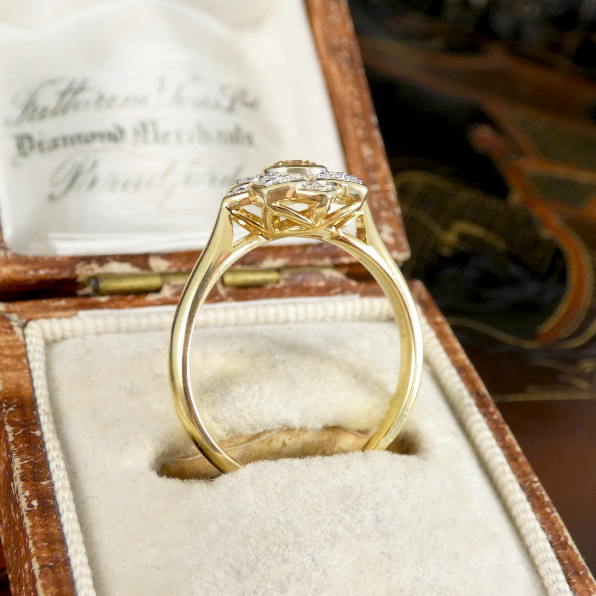 Gold ring with diamond in a wooden box