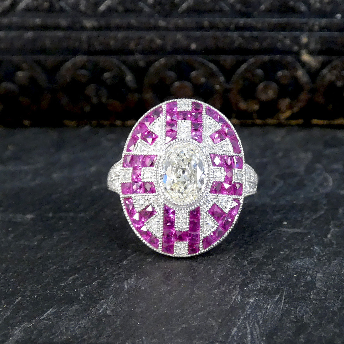 Art Deco Inspired Oval Cut Diamond Cluster Ring with Calibre Cut Rubies in Platinum