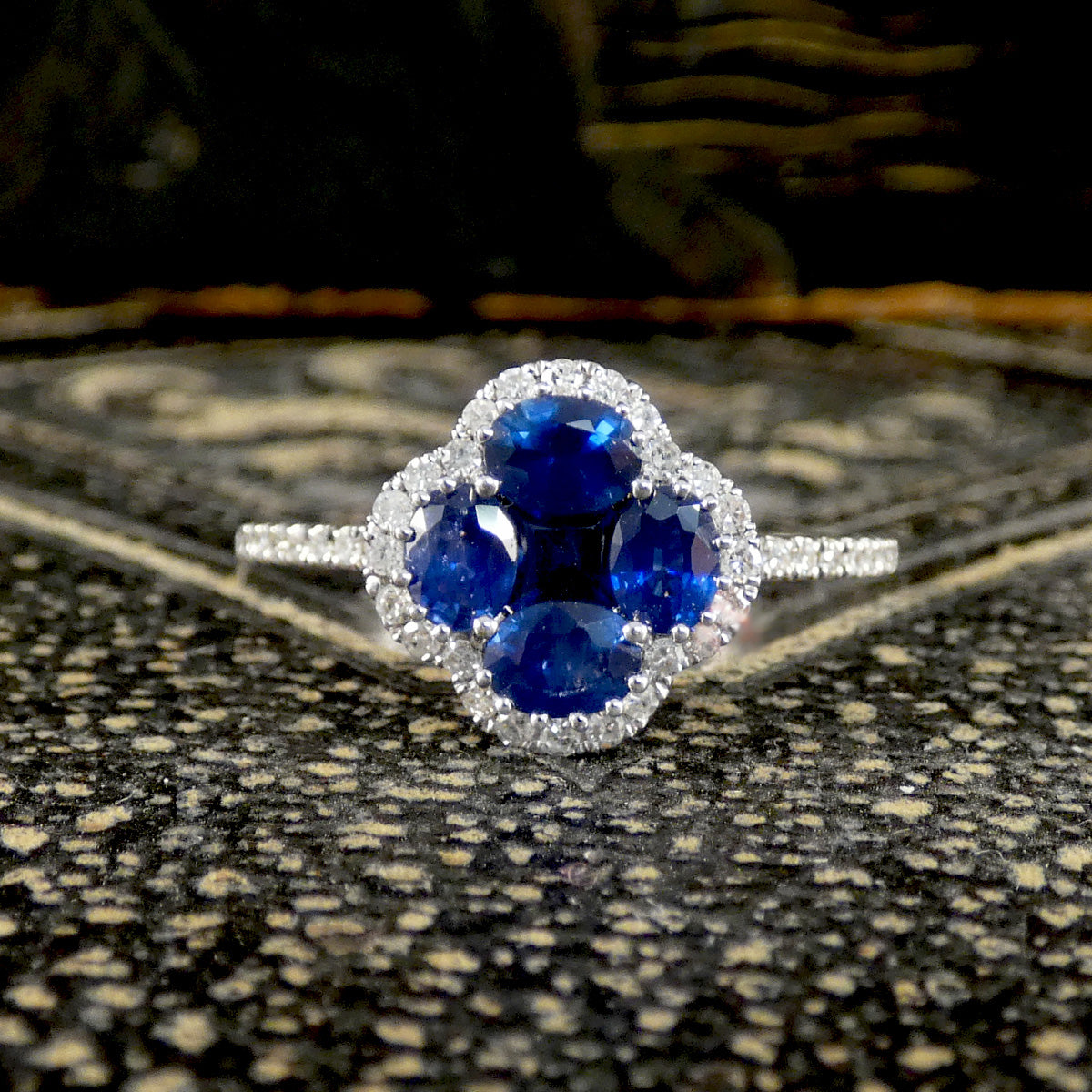 Sapphire and Diamond Shamrock Ring in 18ct White Gold on a dark background