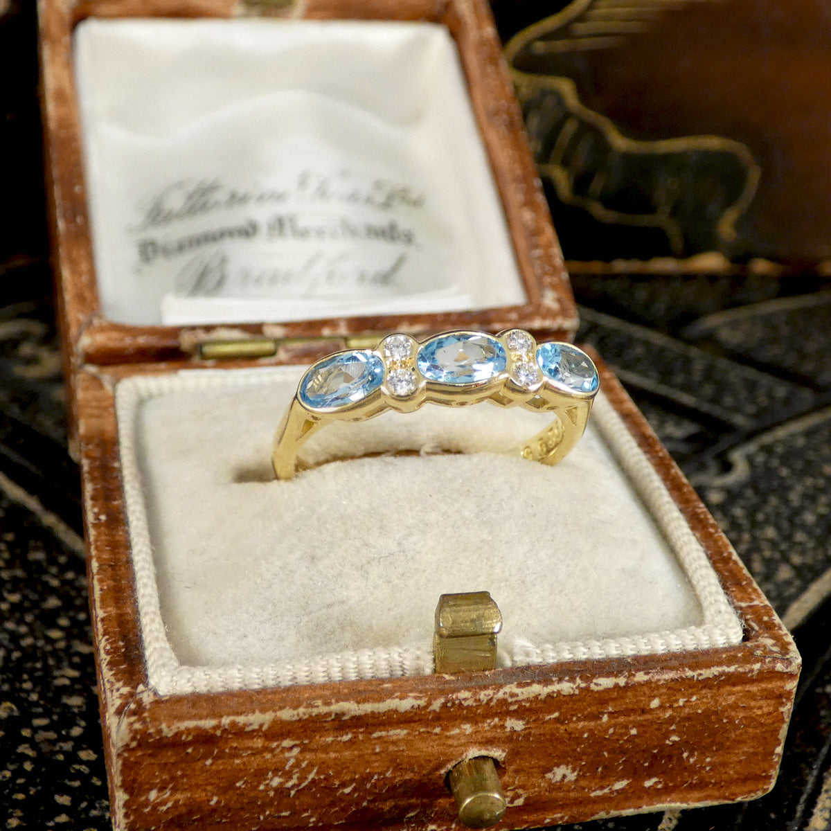 Blue Topaz and Diamonds ring in Yellow Gold shown in vintage box