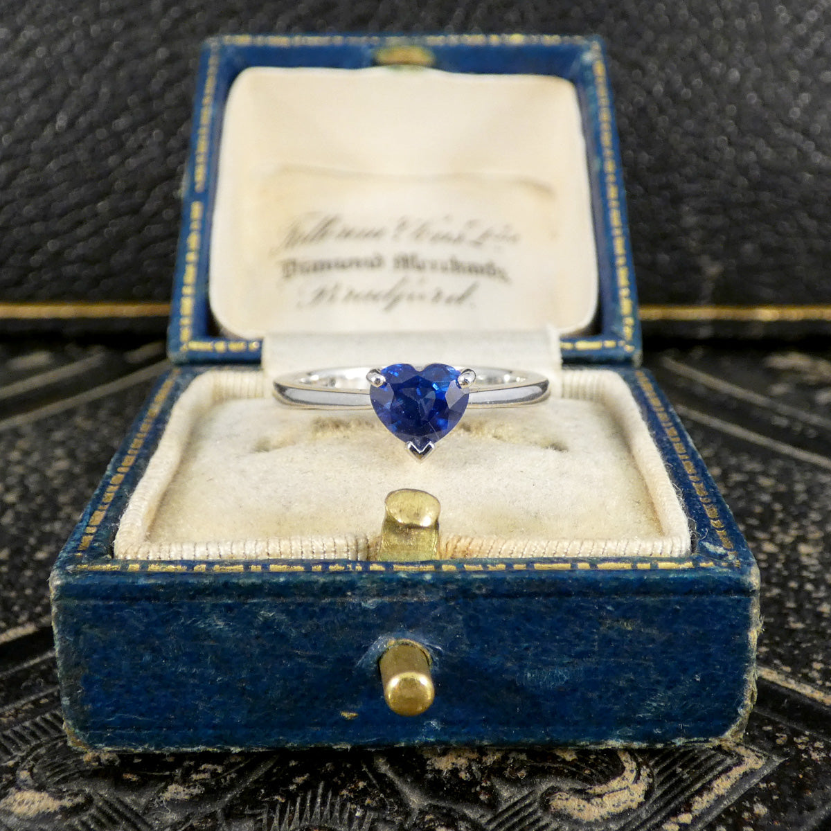 Heart Cut Sapphire solitaire ring in Platinum shown on a jewellery box.