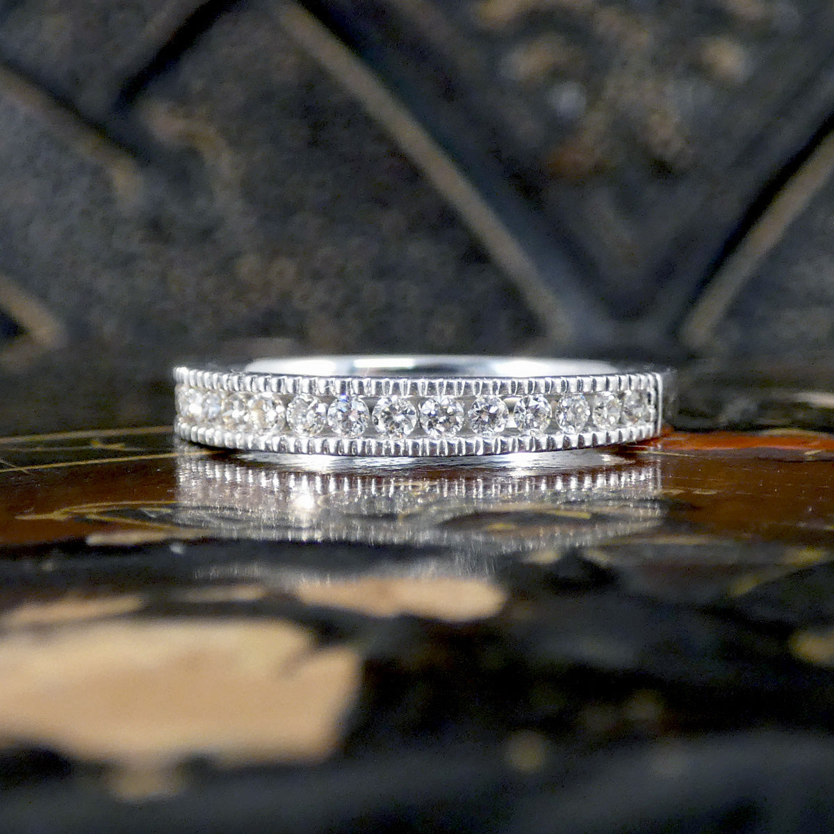 White Gold ring with embedded diamonds on a textured surface
