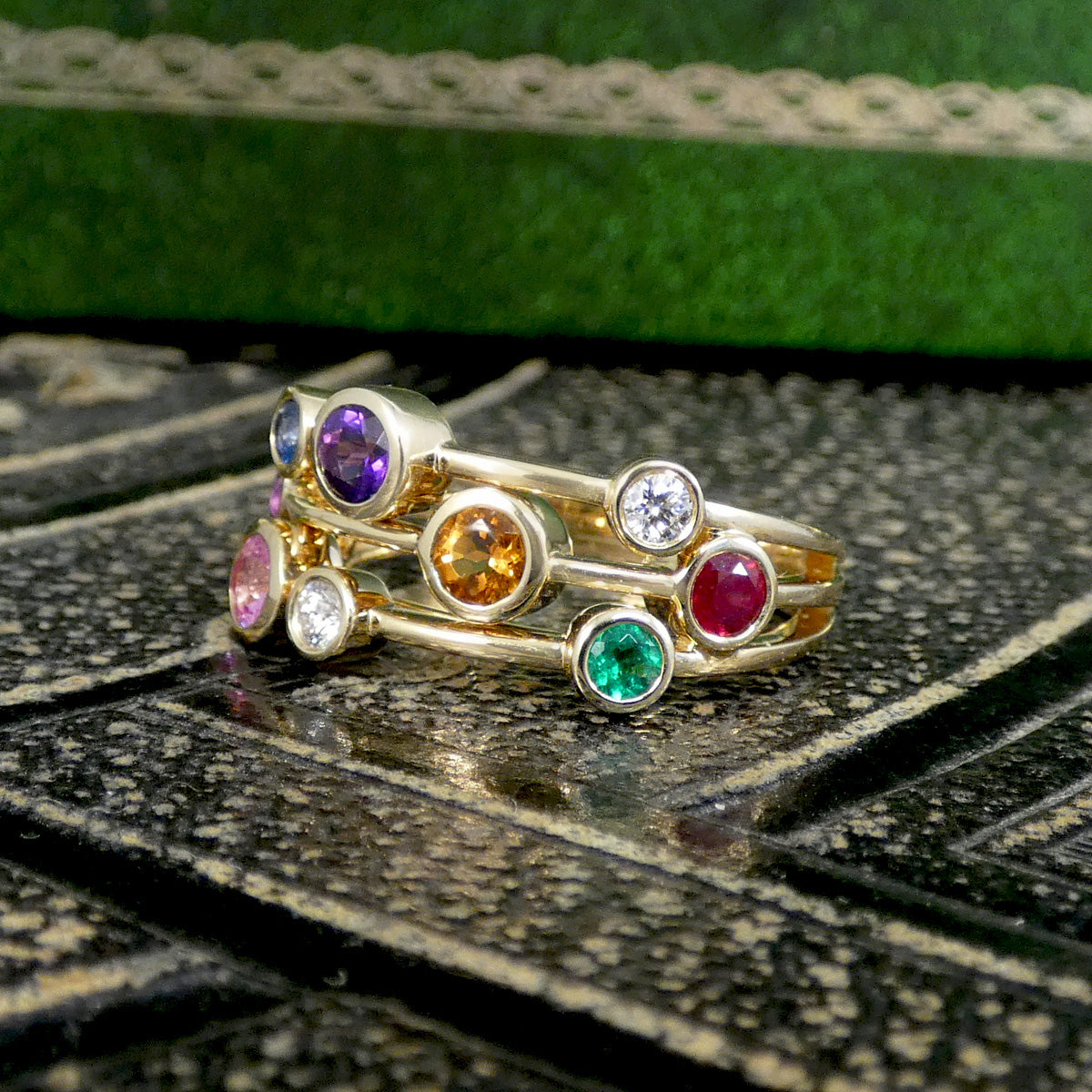 Multi Gem set bubble ring in yellow gold set along three strands