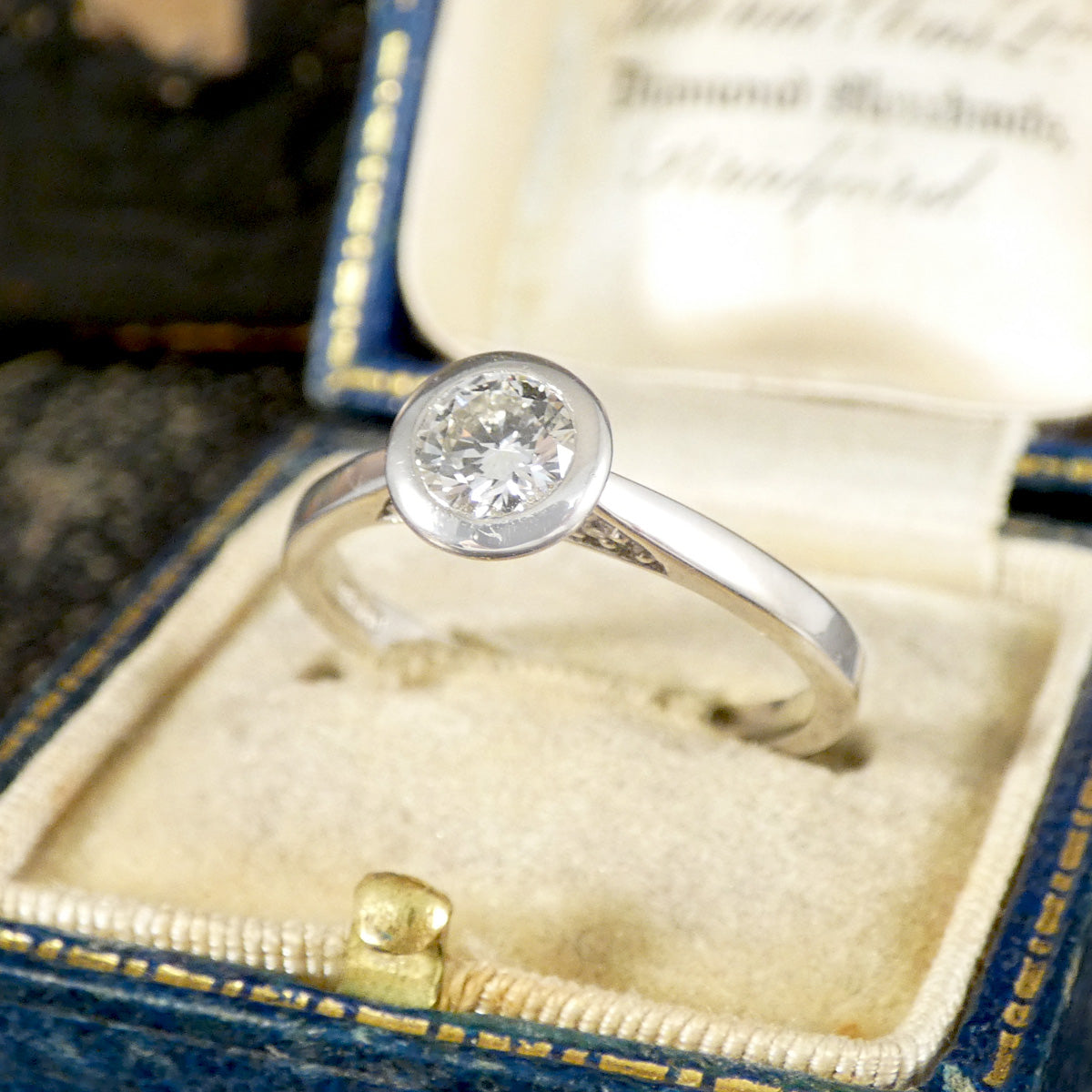 Diamond Solitaire Wedfit Ring in a Rub Over Bezel with a Diamond set Profile shown in vintage box.