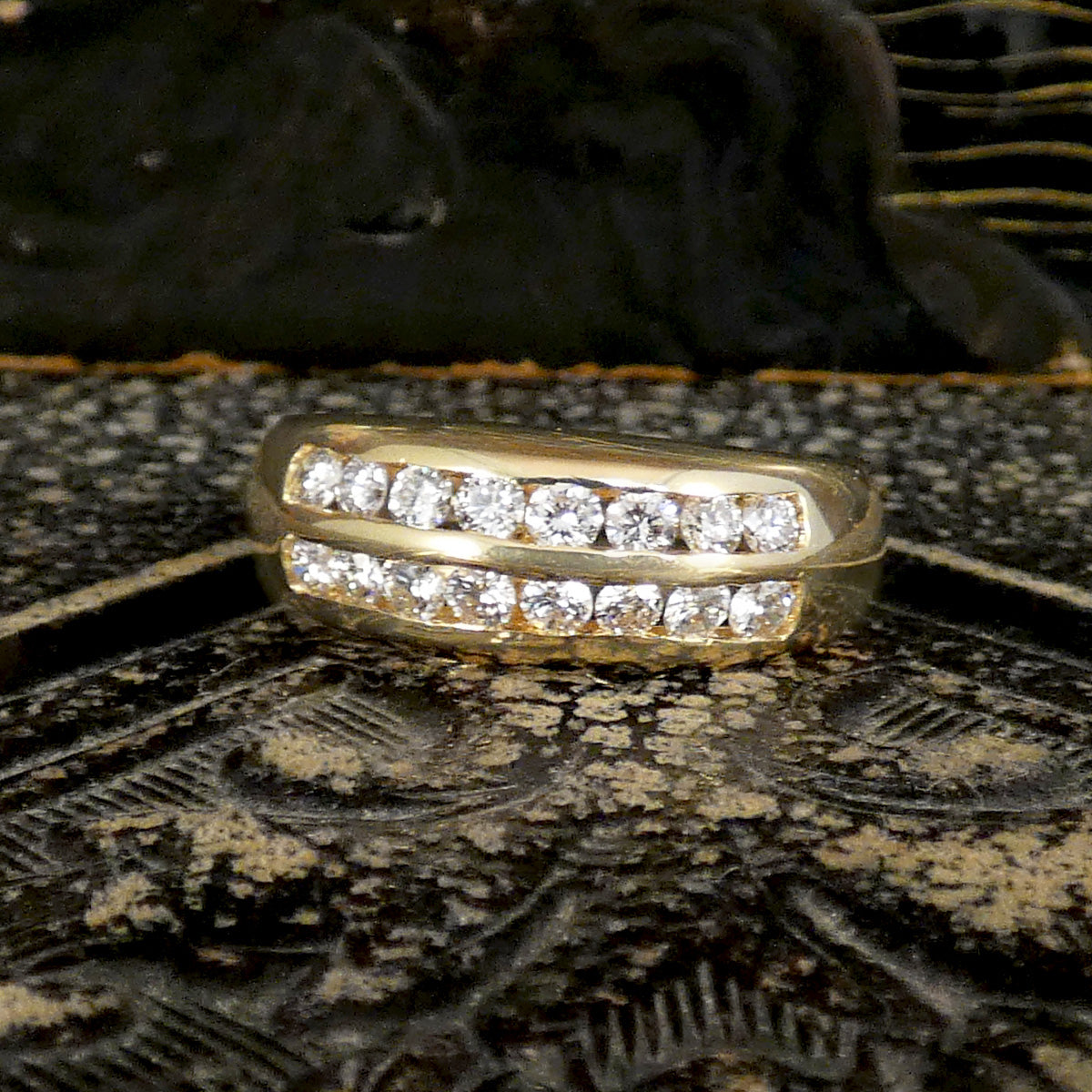 A channel set diamond double row ring in yellow gold