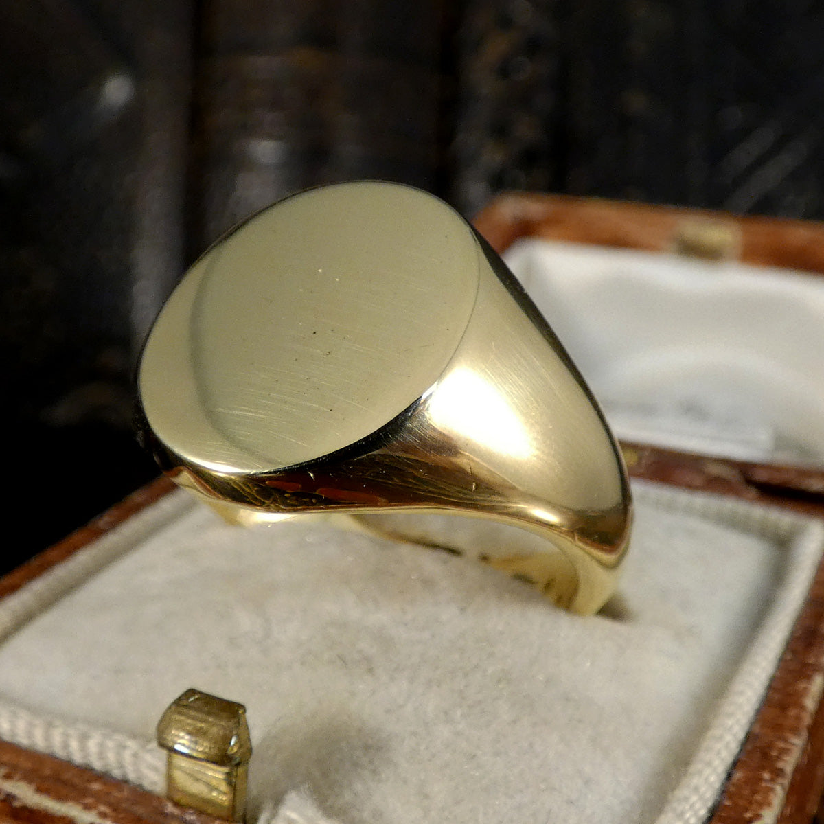 Solid Gold Signet Ring in 18ct Yellow Gold in a jewelry box with a blurred background