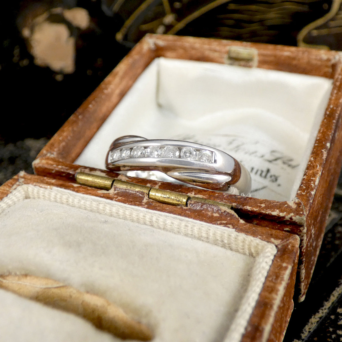 Silver ring with diamonds in an open jewelry box