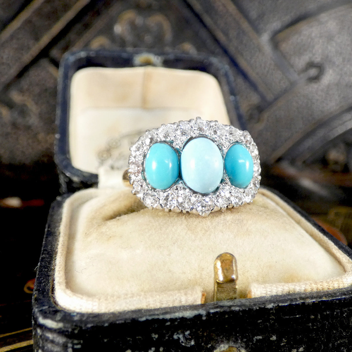 Ring with turquoise stones in a jewelry box