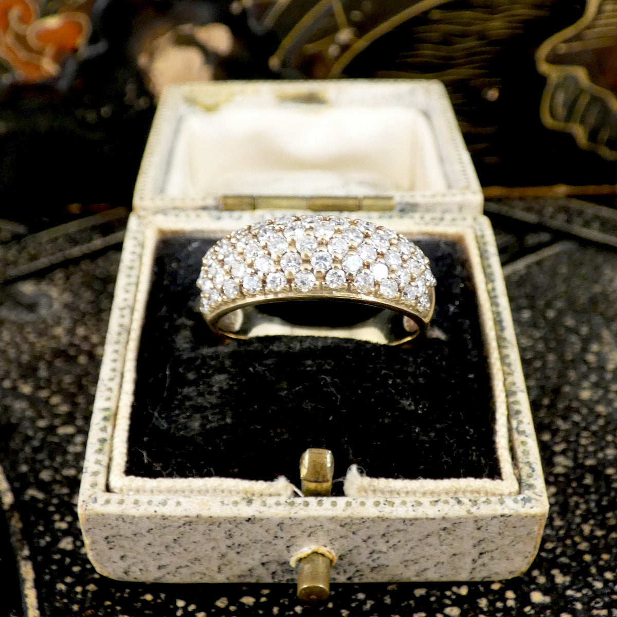 a diamond set domed ring in 9ct yellow gold