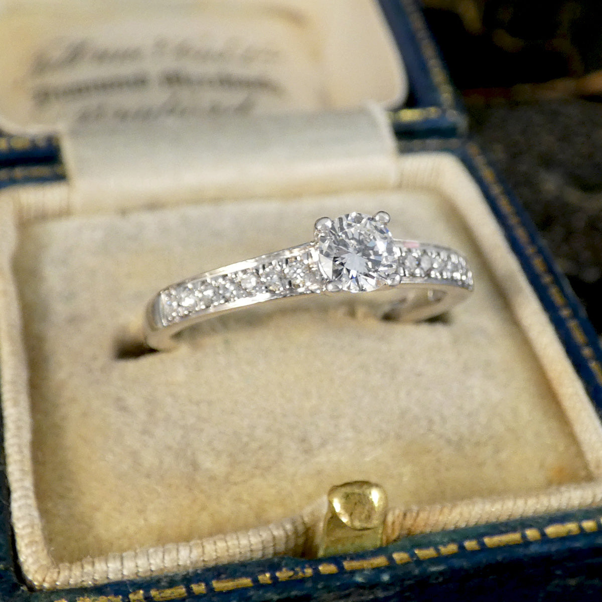 Diamond ring in an open jewelry box with a blurred background