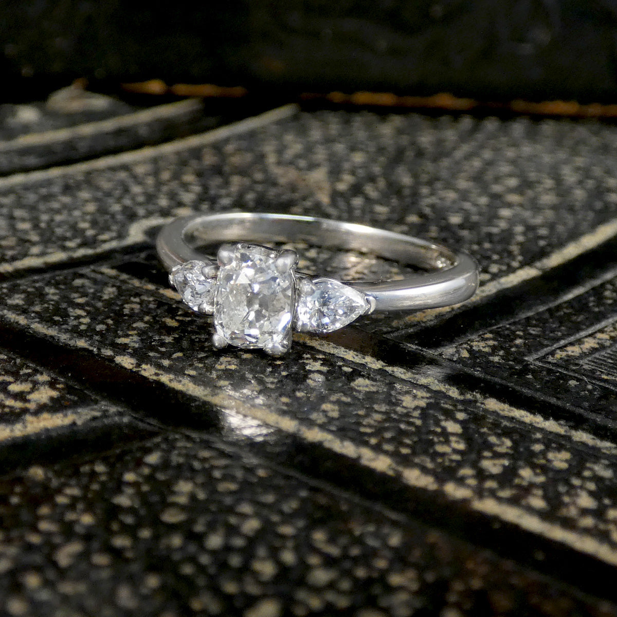 Silver ring with a diamond on a textured surface