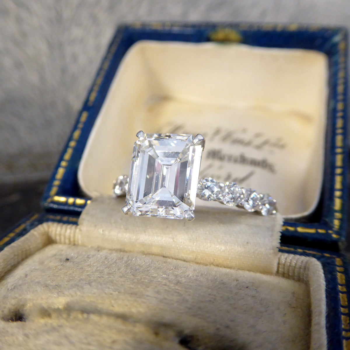 2.60ct Emerald Cut Diamond Solitaire Ring with 0.60ct Diamond Shoulders in Platinum - Wharfedale Antiques