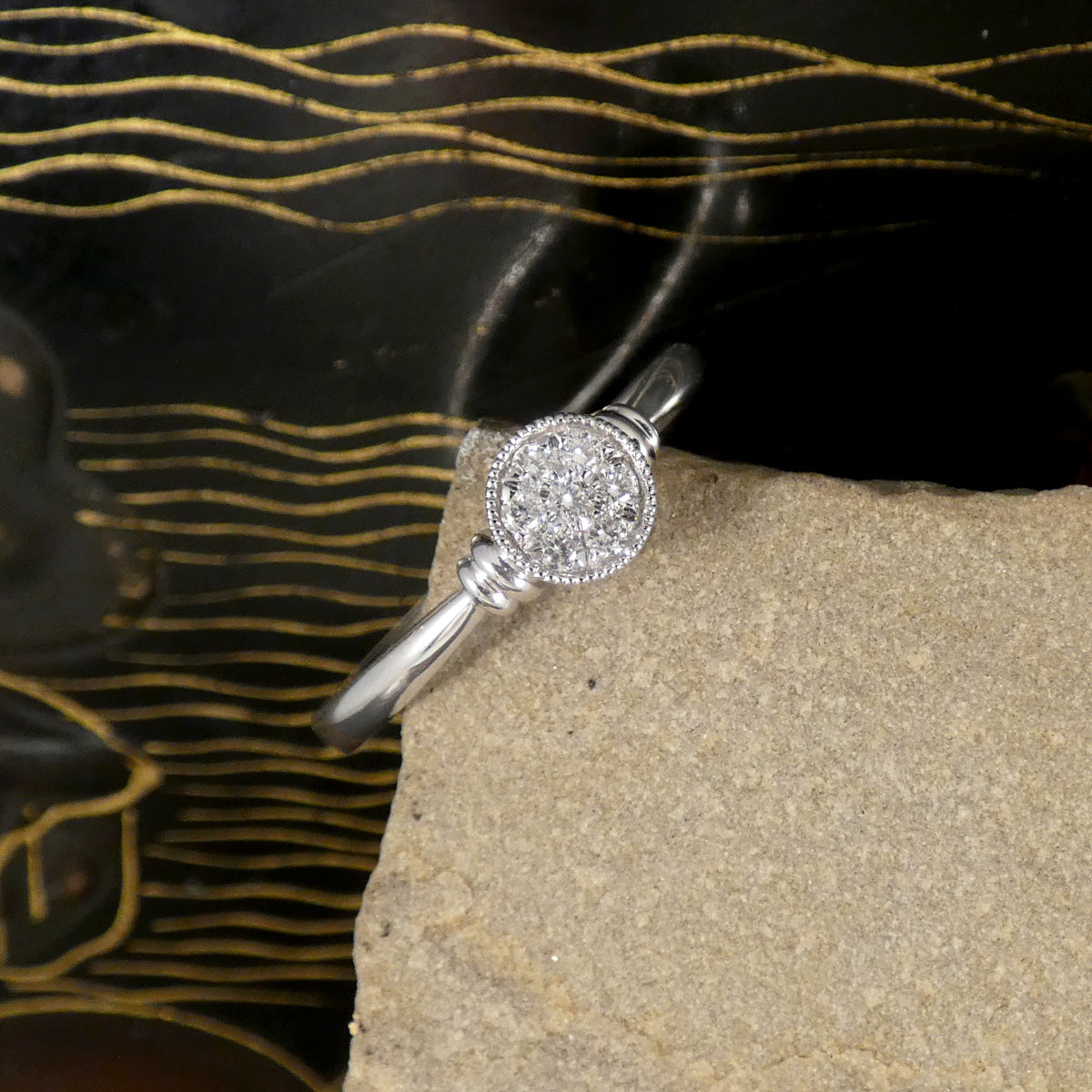A diamond set disc shaped cluster ring with a double donut shoulders in Platinum.