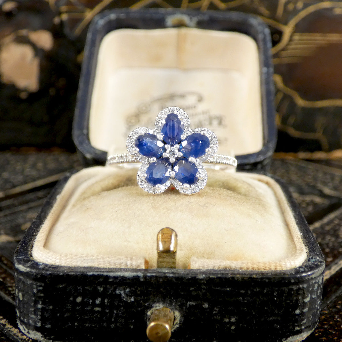Sapphire and Diamond flower cluster ring in 18ct white gold displayed in vintage jewellery box.