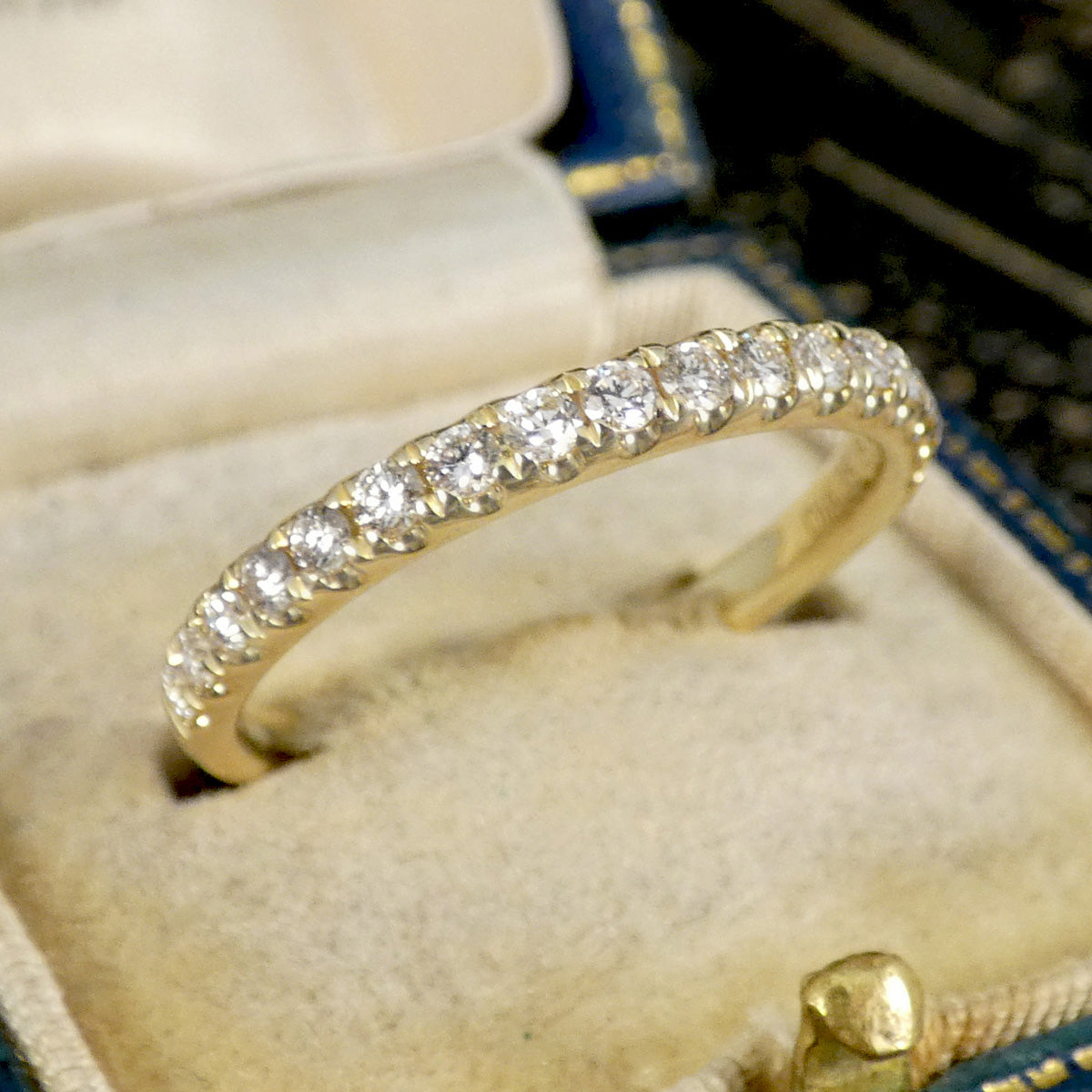 A diamond half eternity ring in yellow gold,  shown in box as perfect wedding ring