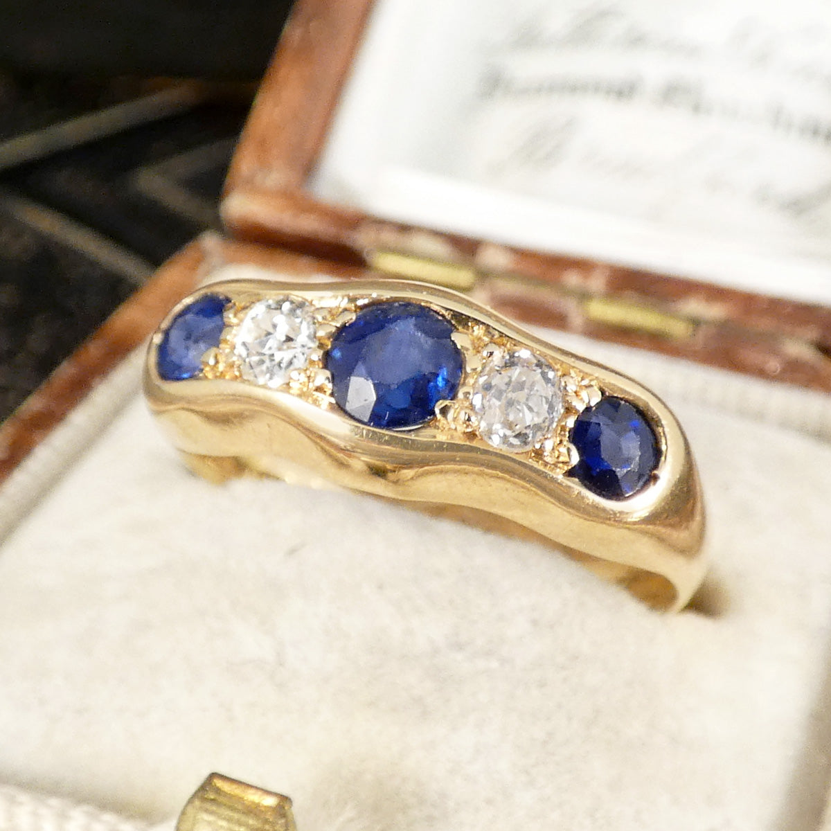 Bright blue sapphires and diamonds in an 18ct yellow gold ring.