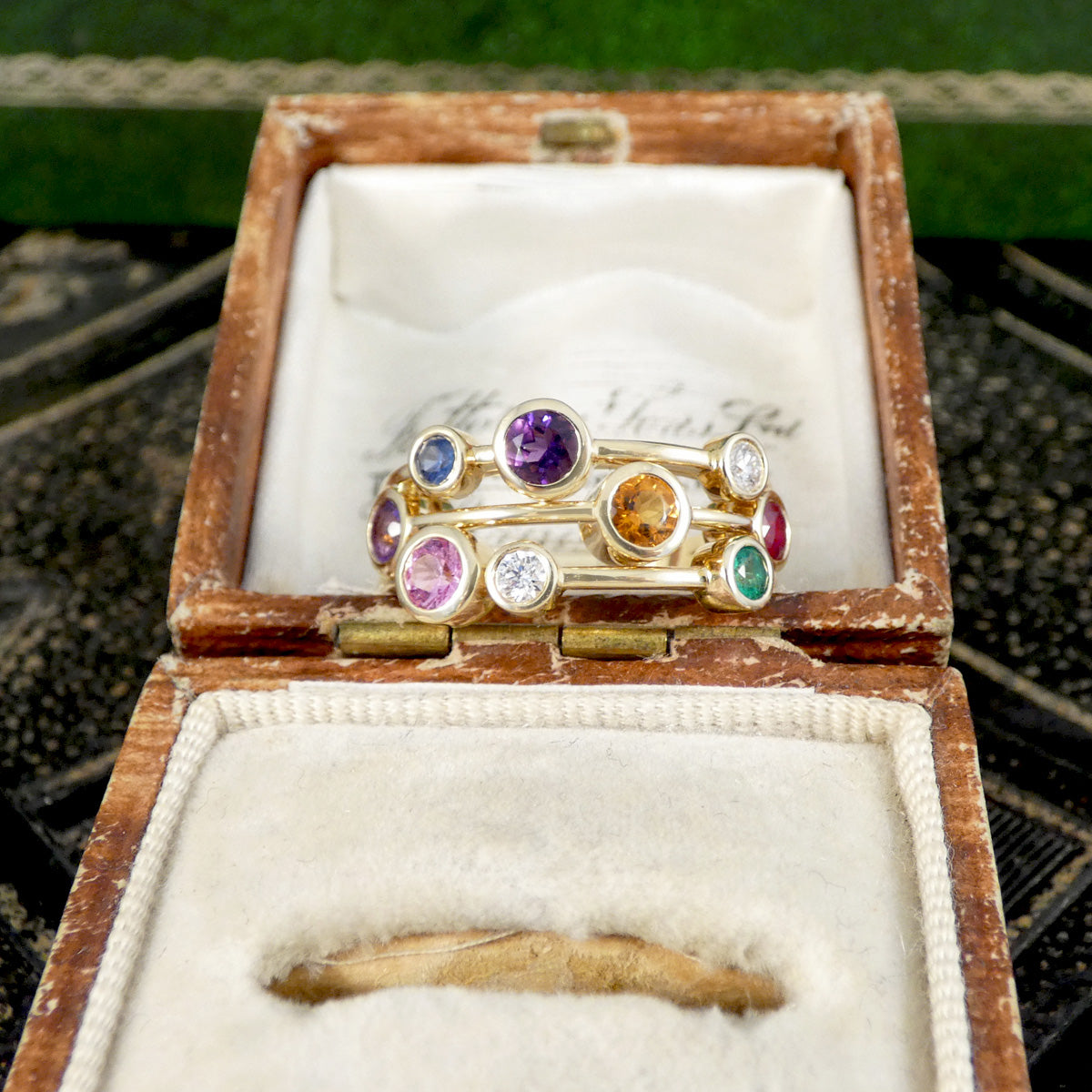 Multi Gem set bubble ring in yellow gold displayed in a jewellery box